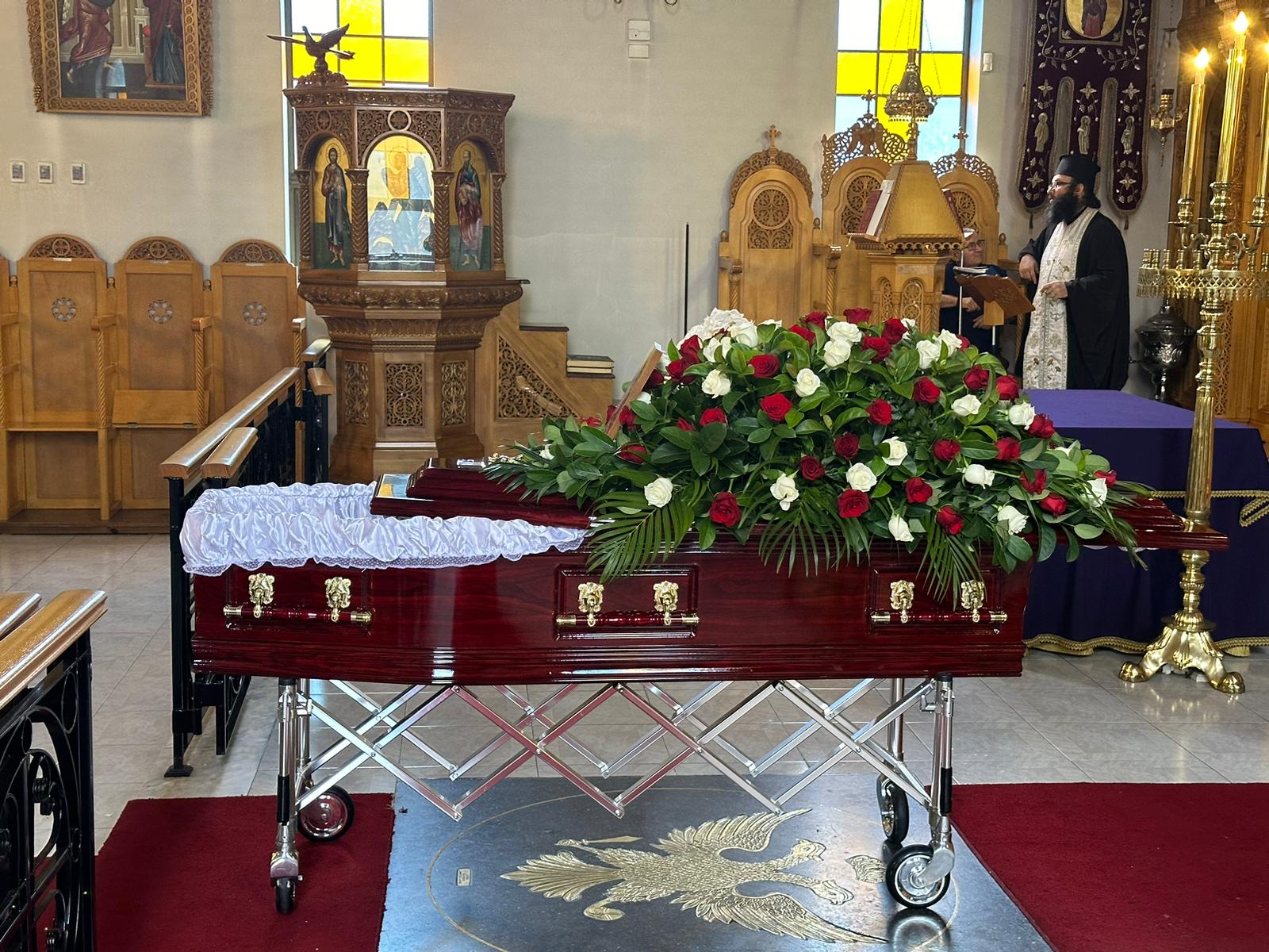 Close-up view of a decorated coffin inside a Greek Orthodox church in Sydney